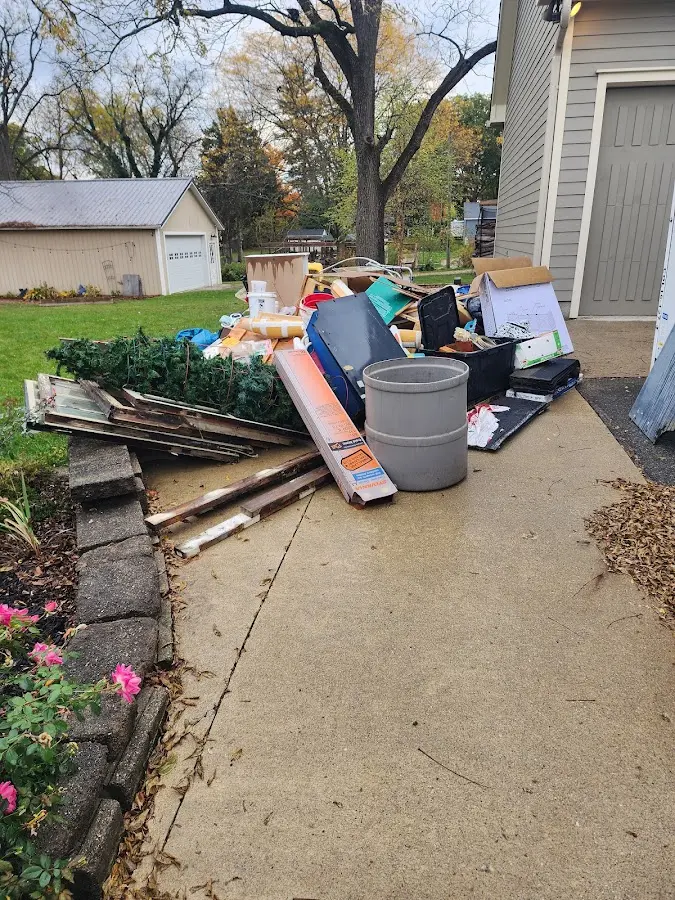 Dumpster being loaded with debris for Estate Cleanout Dumpster Rental in Leitchfield